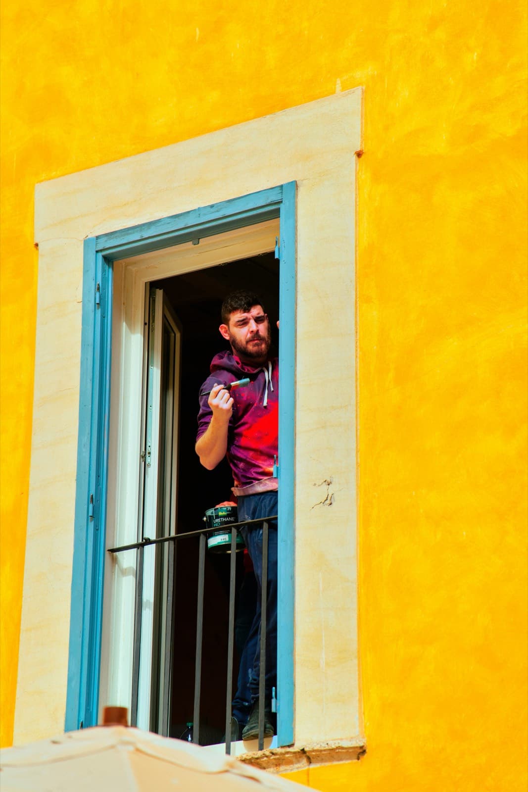 Painter applying paint to an interior wall (illustrative photo)